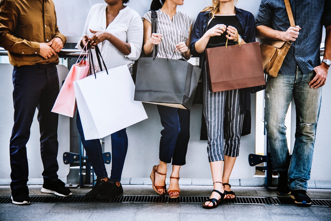 people holding shopping bags