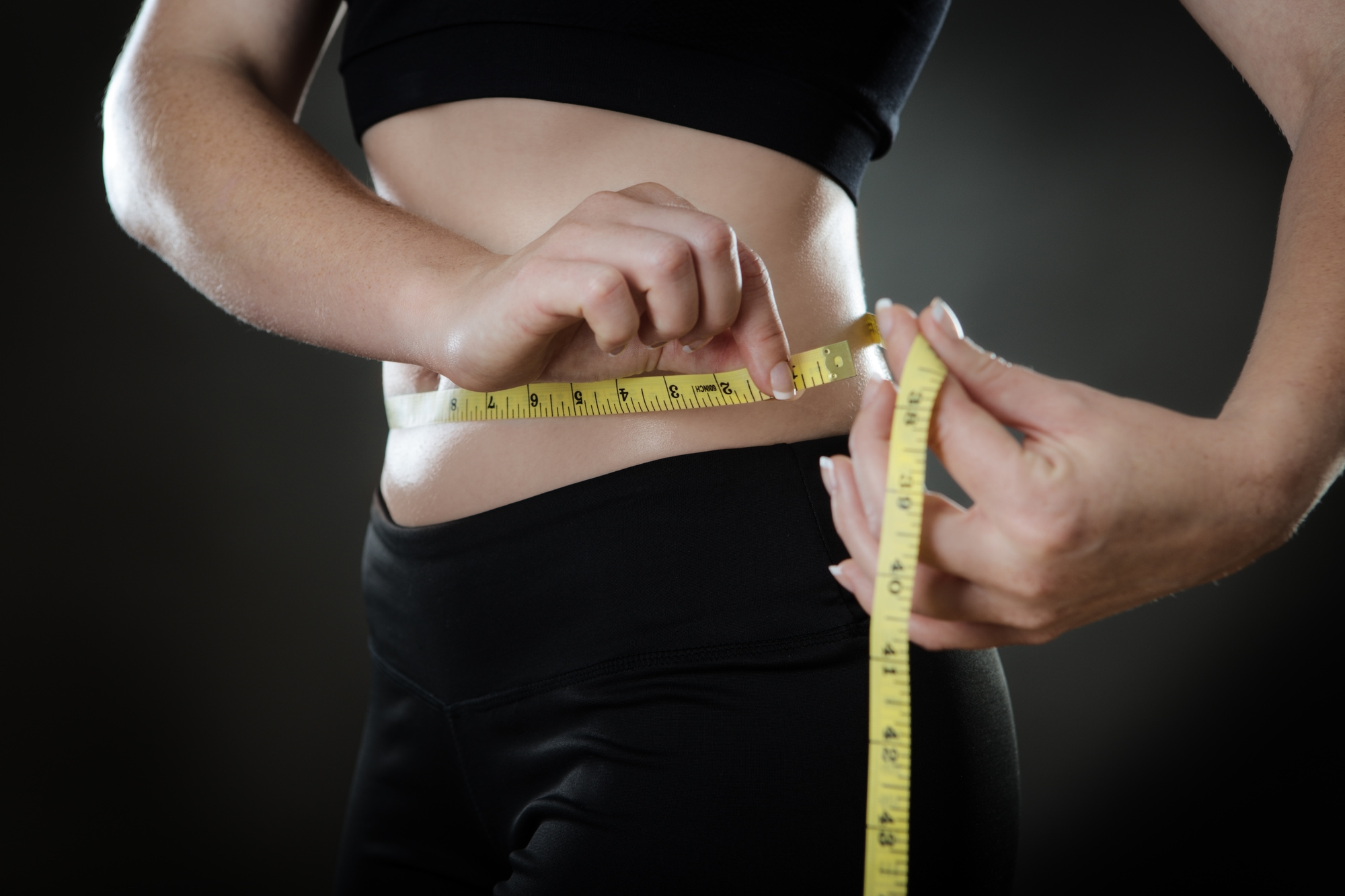 woman measuring her weightloss