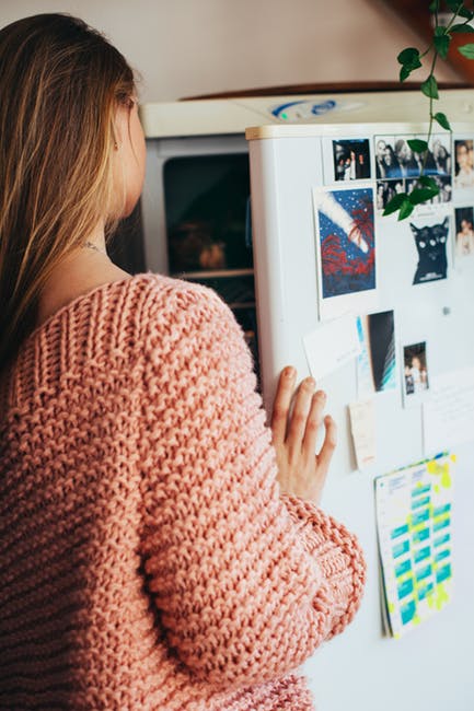 woman looking in fridge