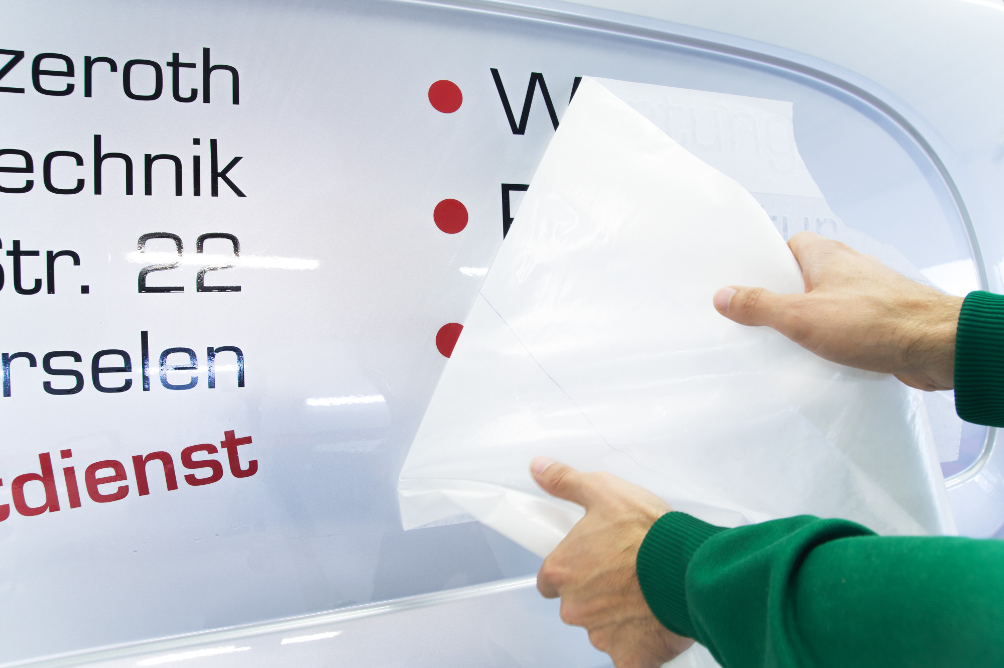 person applying auto decal